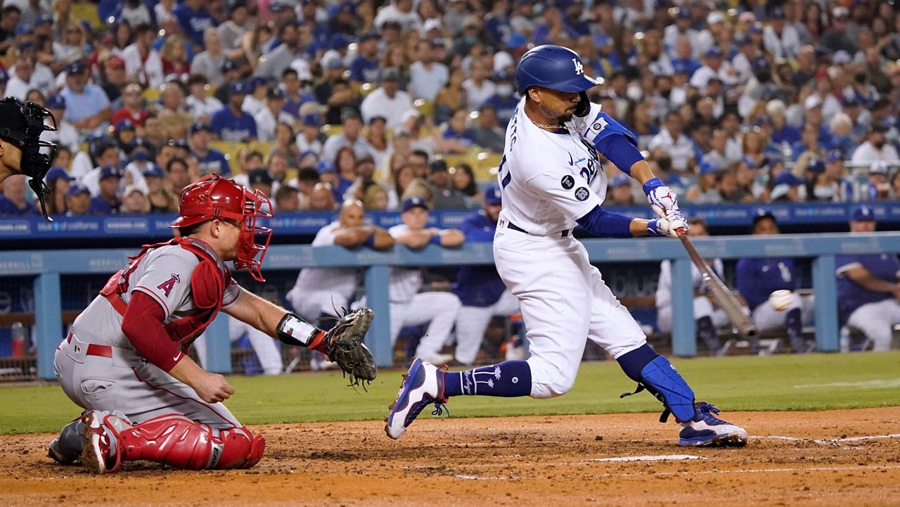Los Angeles Dodgers' Mookie Betts drives in a run with a single during the fourth inning of the team's baseball game against the Los Angeles Angels on Friday, Aug. 6, 2021, in Los Angeles. (AP Photo/Marcio Jose Sanchez)