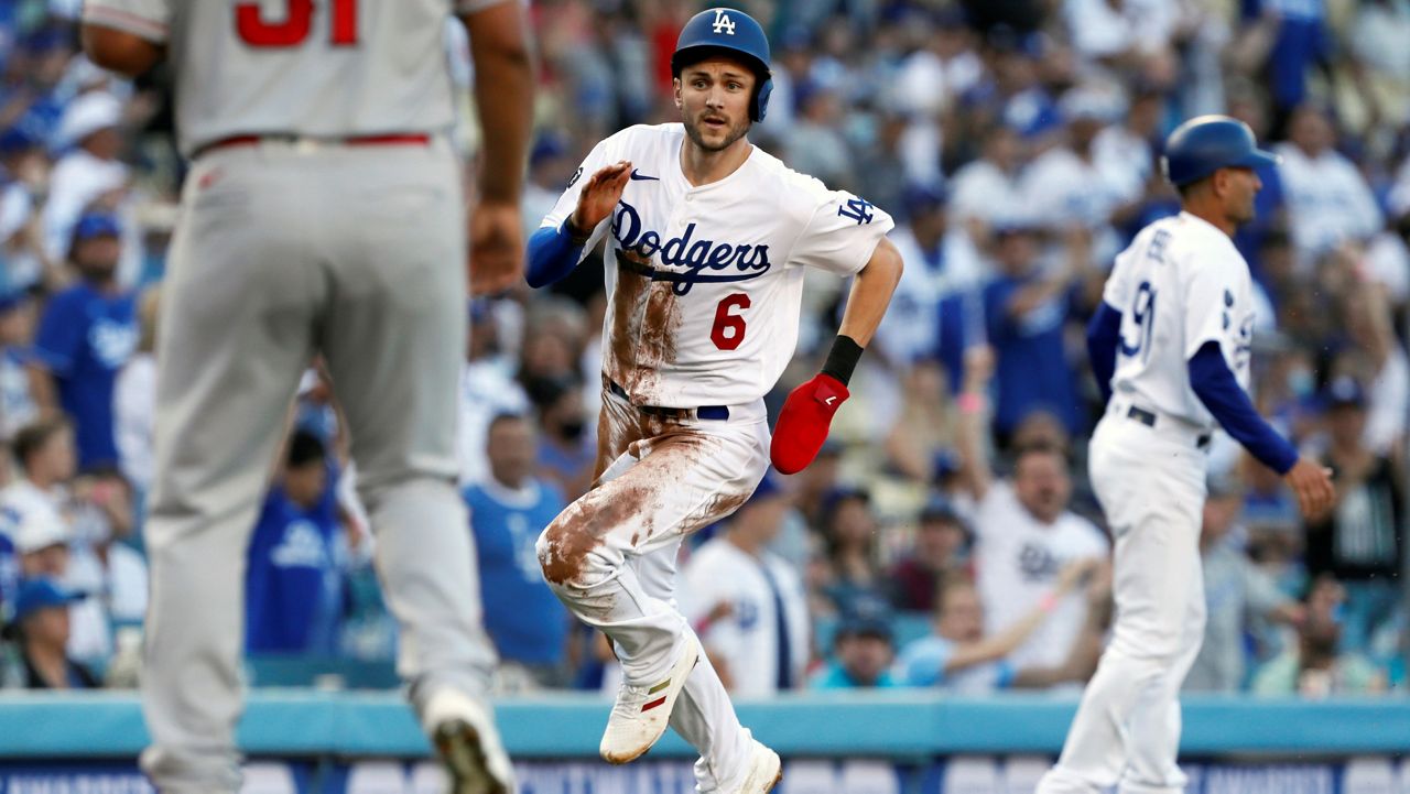 Los Angeles Dodgers' Trea Turner scores on a double by Max Muncy against the Los Angeles Angels during the first inning of a baseball game Saturday in Los Angeles. (AP Photo/Alex Gallardo)