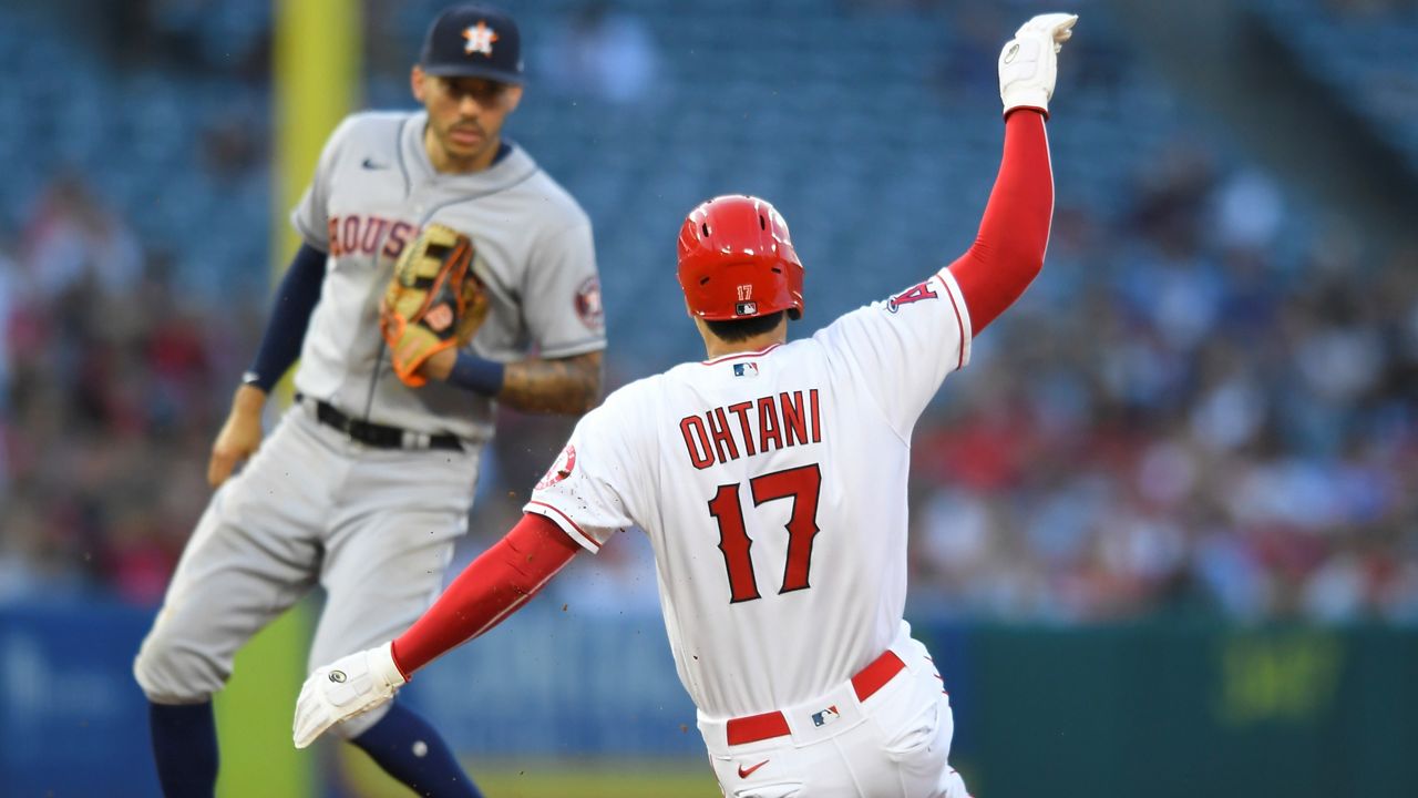 Los Angeles Angels' Shohei Ohtani (17) steals second base while Houston Astros shortstop Carlos Correa looks on in the fourth inning of a baseball game Saturday in Anaheim, Calif. (AP Photo/John McCoy)