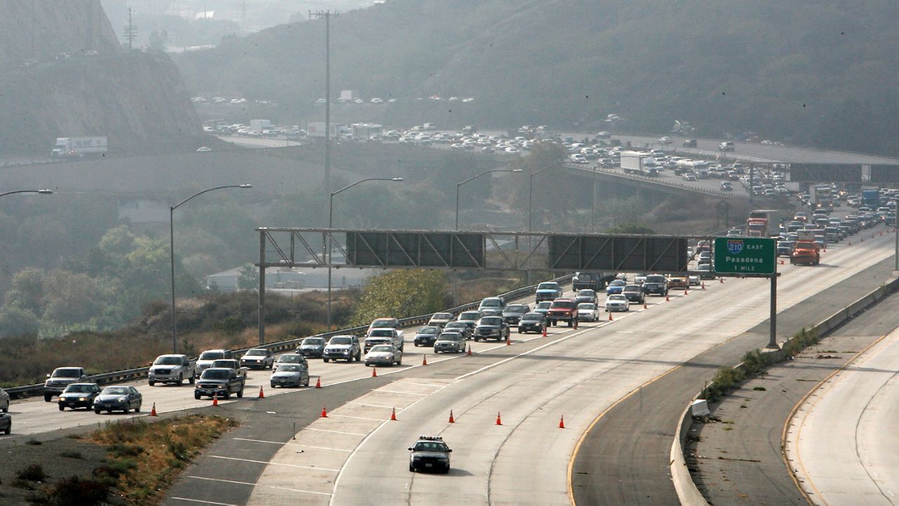 This Oct. 13, 2007, file photo shows the northbound interstate 5 traffic being diverted after a 15-truck pileup on the Golden State Freeway in northern Los Angeles County. (AP Photo/Gus Ruelas)