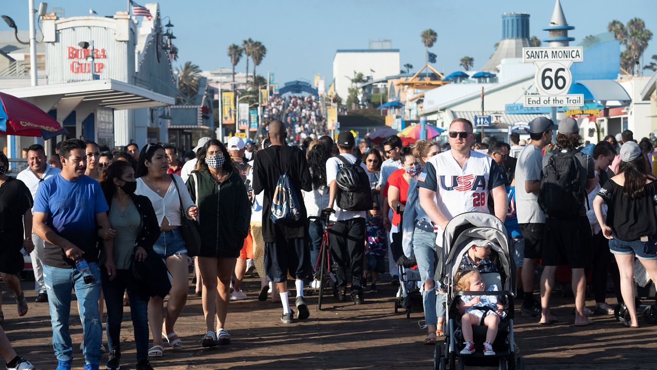 A crowd gathers on the pier to celebrate Independence Day on July 4, 2021, in Santa Monica, Calif. (AP Photo/Kyusung Gong)