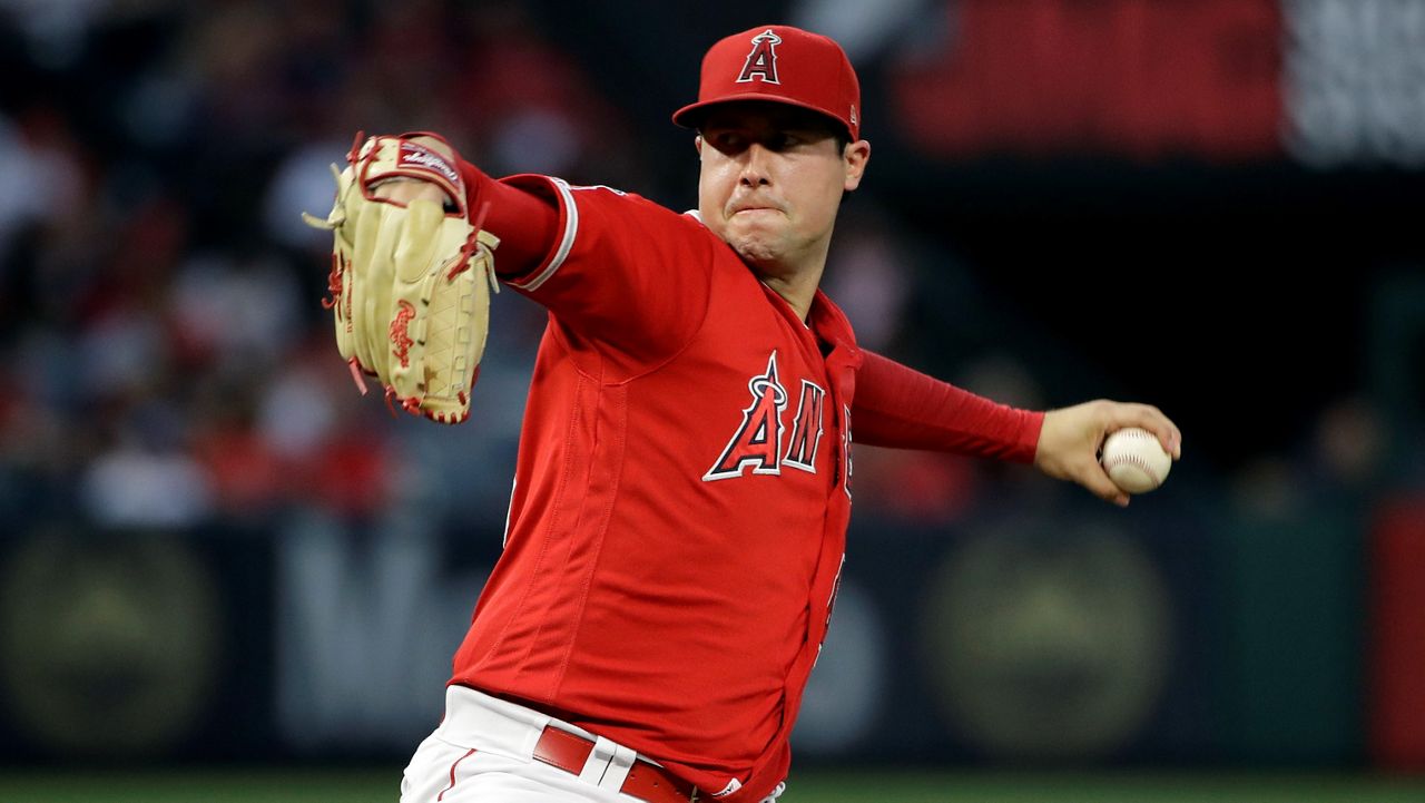 In this June 29, 2019, file photo, Los Angeles Angels starting pitcher Tyler Skaggs throws to the Oakland Athletics during a baseball game in Anaheim, Calif. The family of former Los Angeles Angels pitcher Tyler Skaggs filed lawsuits on June 29, 2021, in Texas and California charging the team and two former employees with negligence in his drug-related death two years ago. Skaggs, 27, was found dead in a suburban Dallas hotel room on July 1, 2019. (AP Photo/Marcio Jose Sanchez)