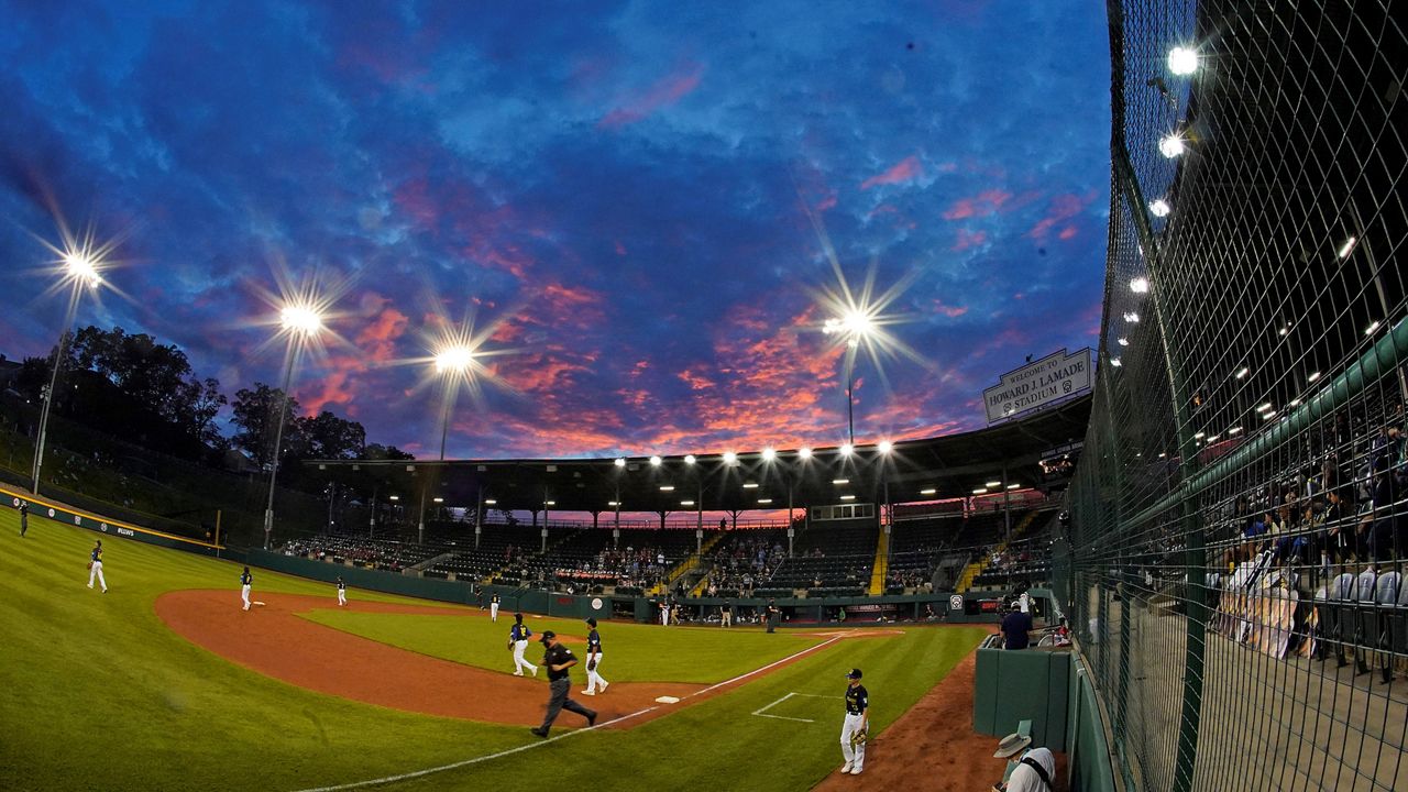 In this Aug. 19, 2021, file photo, the sun sets behind Lamade Stadium during a baseball game at the Little League World Series tournament in South Williamsport, Pa. (AP Photo/Gene J. Puskar)
