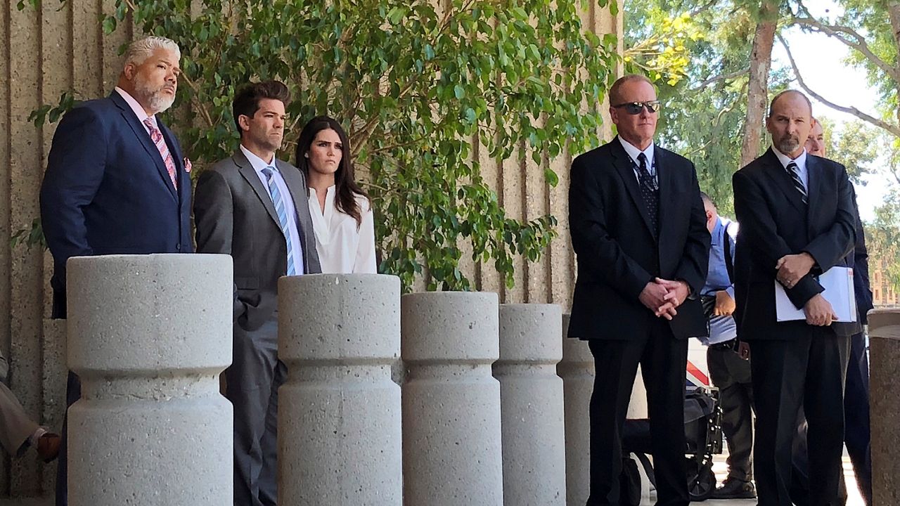 In this Oct. 17, 20218, file photo, reality show doctor Grant Robicheaux and his girlfriend Cerissa Riley, second and third from left, stand outside court in Newport Beach, Calif., following their hearing on new criminal charges involving five additional victims. The pair were previously charged with drugging and sexually assaulting two women. (AP Photo/Amy Taxin)