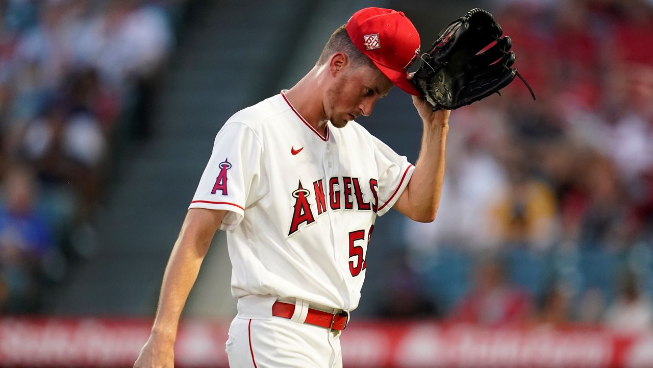 Los Angeles Angels starting pitcher Cooper Criswell walks to the dugout after he was removed from the mound during the second inning of a baseball game Friday against the San Diego Padres in Anaheim, Calif. (AP Photo/Ashley Landis)