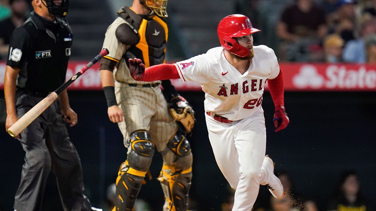 Los Angeles Angels' Jared Walsh, right, watches his RBI-double during the fourth inning of a baseball game Saturday against the San Diego Padres in Anaheim, Calif. (AP Photo/Jae C. Hong)