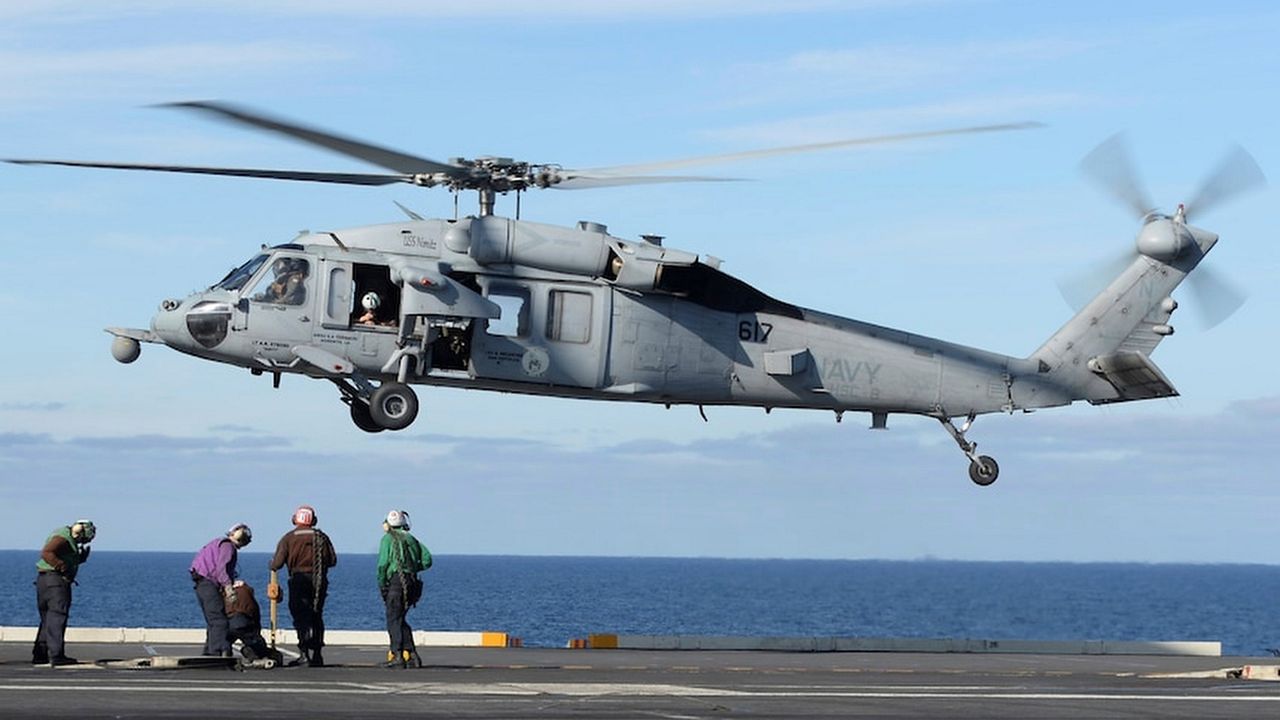 In this March 19, 2017, photo released by the U.S. Navy, an MH-60S Sea Hawk helicopter prepares to land on the flight deck of the aircraft carrier USS Nimitz in the Pacific Ocean. (Mass Communication Specialist Seaman Ian Kinkead/U.S. Navy via AP)