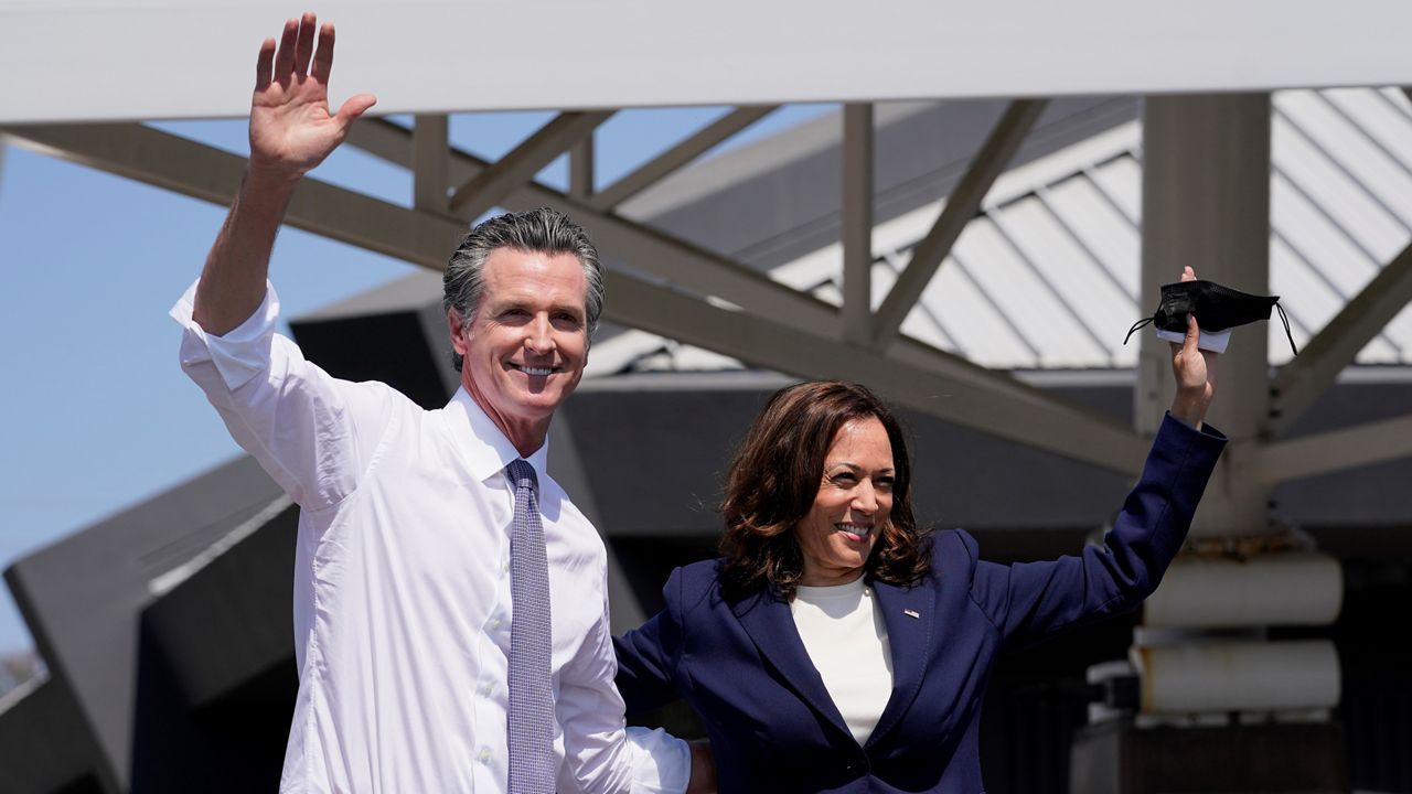 California Gov. Gavin Newsom and Vice President Kamala Harris wave during a campaign event Wednesday at the IBEW-NECA Joint Apprenticeship Training Center in San Leandro, Calif. (AP Photo/Carolyn Kaster)