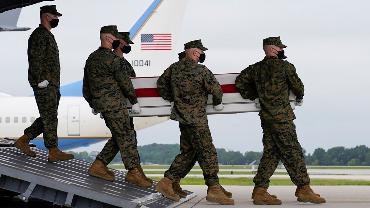 A carry team moves a transfer case containing the remains of Marine Corps Lance Cpl. Jared M. Schmitz, 20, of St. Charles, Mo., during a casualty return Sunday, Aug. 29, 2021, at Dover Air Force Base, Del. (AP Photo/Carolyn Kaster)