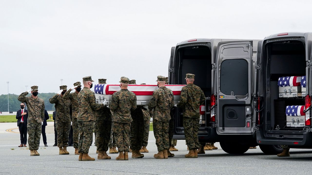 Marine Corps carry team loads a transfer case containing the remains of Marine Corps Lance Cpl. Kareem Mae'Lee Grant Nikoui, 20, of Norco, Calif., at Dover Air Force Base, Del.  (AP Photo/Manuel Balce Ceneta)