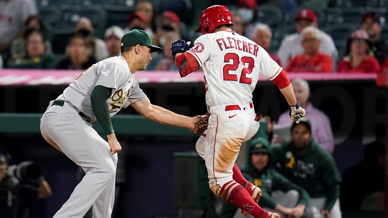 Los Angeles Angels' David Fletcher (22) is tagged out by Oakland Athletics first baseman Matt Olson during the seventh inning of a baseball game Friday in Anaheim, Calif. (AP Photo/Ashley Landis)