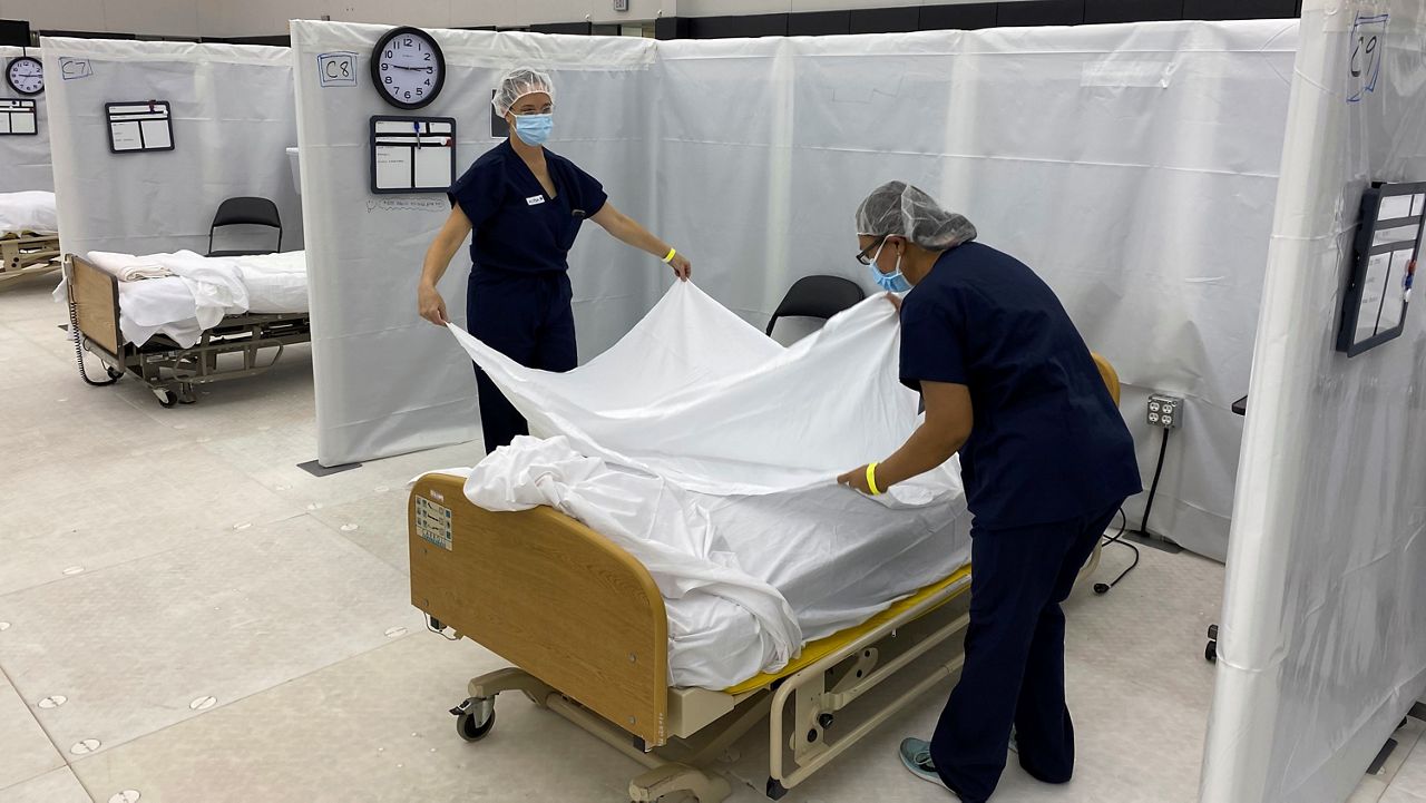This Dec. 9, 2020, file photo from the California Office of Emergency Services (OES) shows hospital beds set up in the practice facility at Sleep Train Arena in Sacramento, Calif. (California OES via AP)