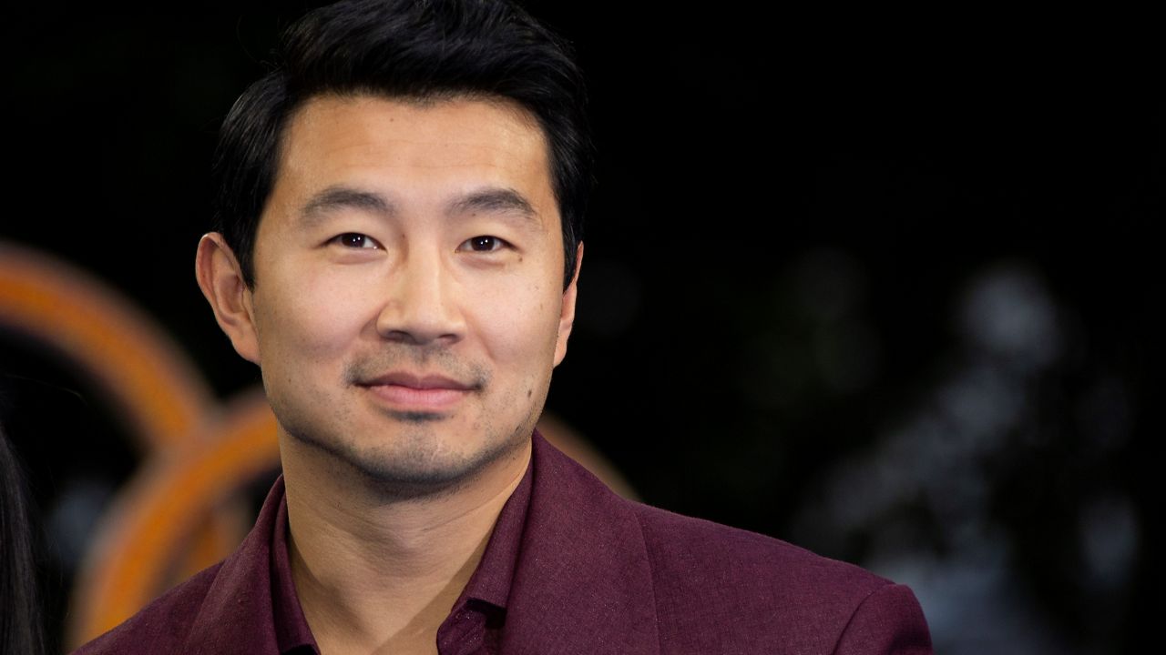 Actor Simu Liu poses for photographs on the red carpet for the premiere of Shang-Chi and the Legend of the Ten Rings at a cinema on Aug. 26, 2021, in west London. (Photo by Joel C Ryan/Invision/AP)