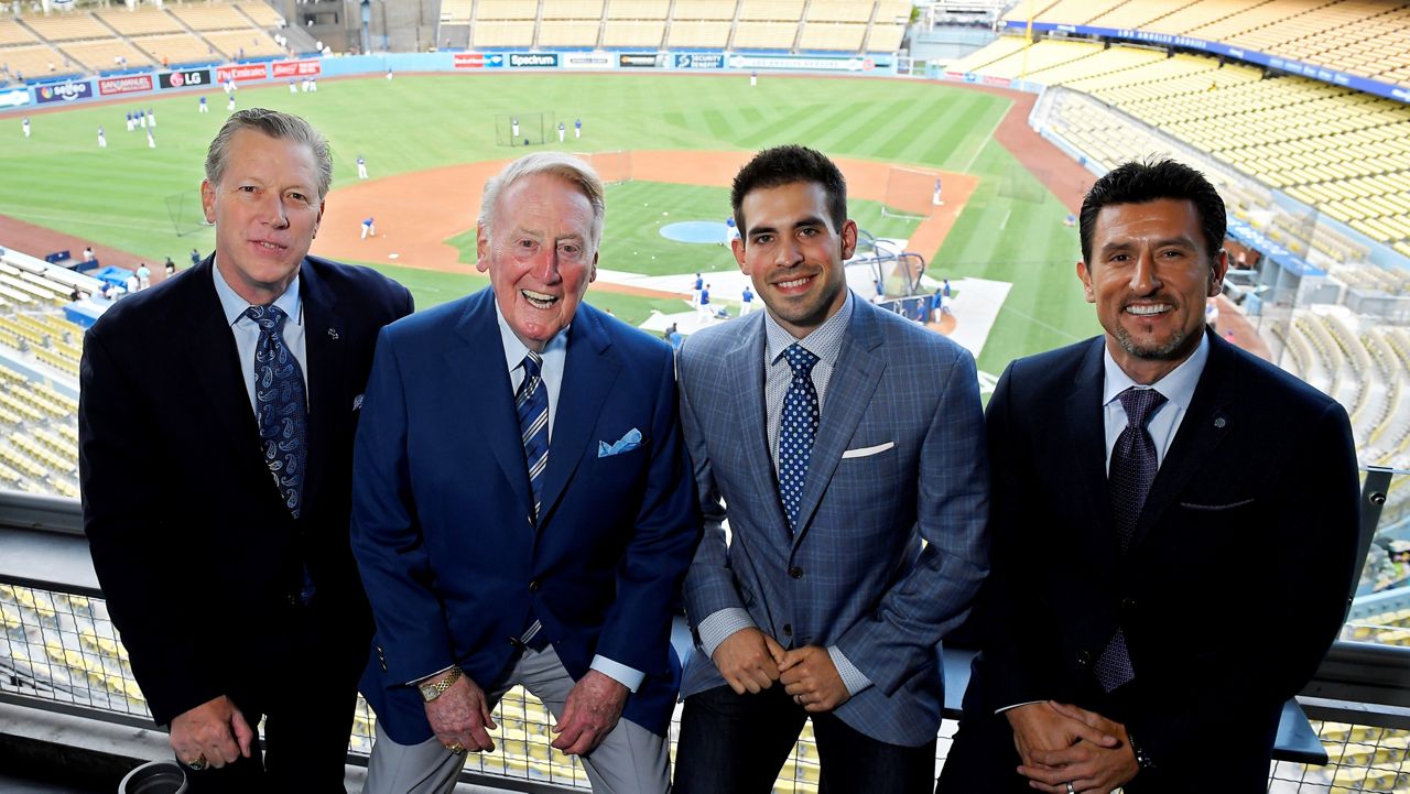 In this Sept. 20, 2016, file photo, Dodgers broadcasters, from left, Orel Hershiser, Vin Scully, Joe Davis and Nomar Garciaparra pose prior to a baseball game between the Los Angeles Dodgers and the San Francisco Giants in Los Angeles. (AP Photo/Mark J. Terrill)