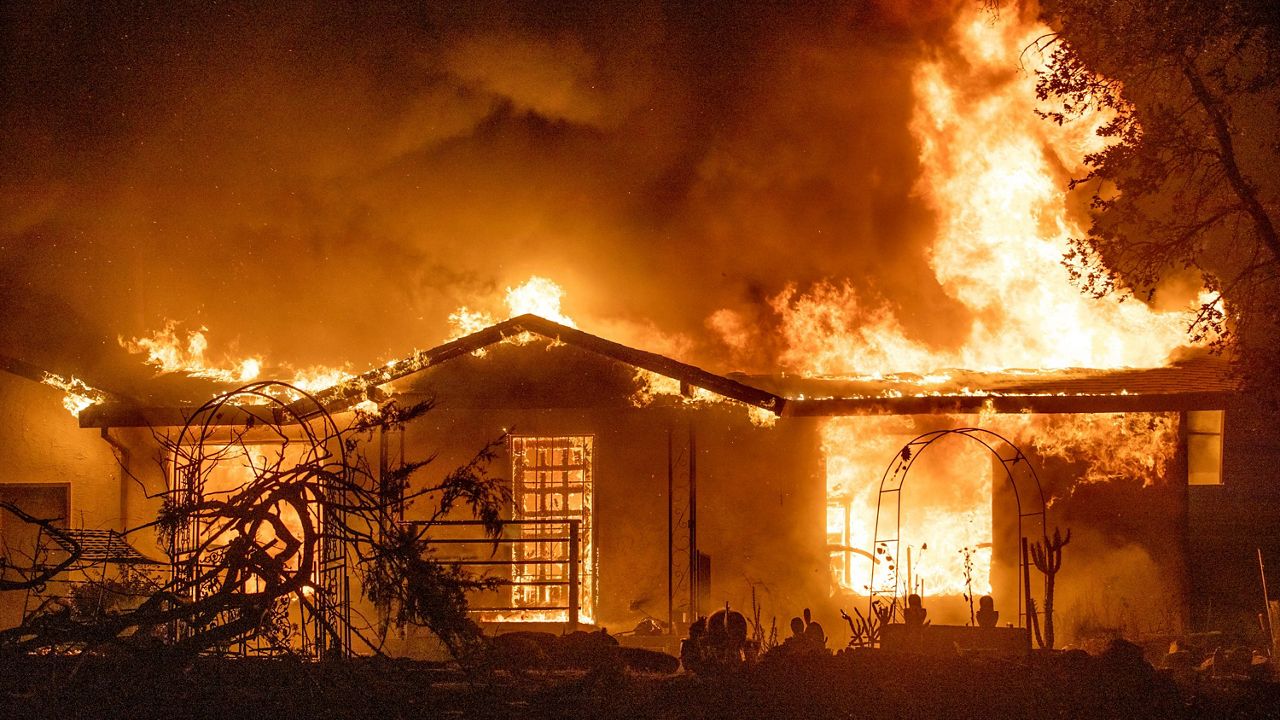 A house burns on Platina Road at the Zogg Fire near Ono, Calif., on Sep. 27, 2020. (AP Photo/Ethan Swope, File) 