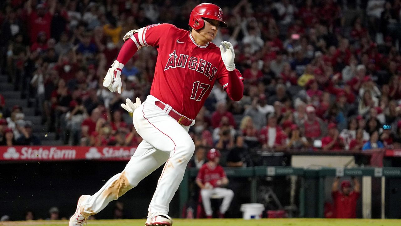 Los Angeles Angels designated hitter Shohei Ohtani rounds first on his way to a triple during the third inning of a baseball game Saturday against the Seattle Mariners in Anaheim, Calif. (AP Photo/Mark J. Terrill)