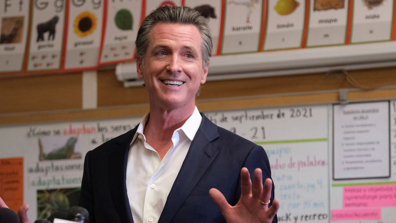 Gov. Gavin Newsom speaks to the press after visiting with students at Melrose Leadership Academy, a TK-8 school in Oakland, Calif., on Sept. 15, 2021, one day after defeating a Republican-led recall effort. (AP Photo/Nick Otto)