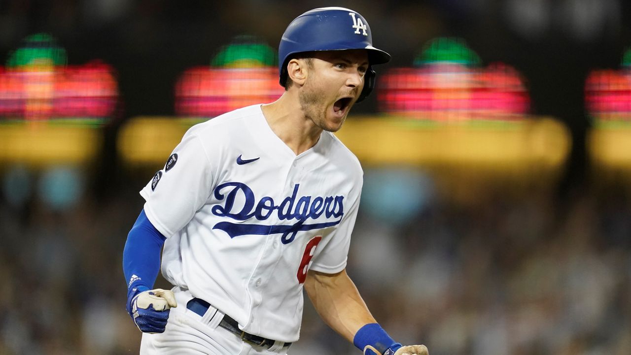 Los Angeles Dodgers' Trea Turner reacts as he runs the bases after hitting a grand slam home run during the fifth inning of a baseball game Friday against the Milwaukee Brewers in Los Angeles. Austin Barnes, Albert Pujols, and Mookie Betts also scored. (AP Photo/Ashley Landis)
