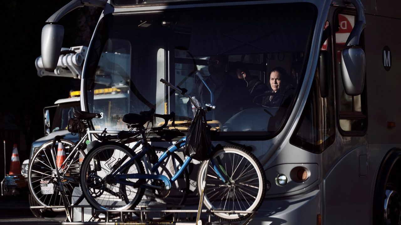 In this Jan. 9, 2019, file photo, a Los Angeles Metro bus driver makes her way through an intersection in Los Angeles. (AP Photo/Richard Vogel)