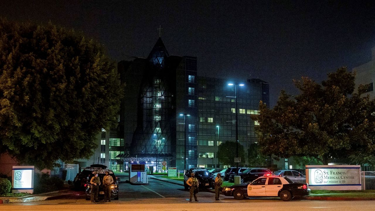 In this Sept. 13, 2020, file photo, Los Angeles County Sheriff's deputies guard the entrance to St. Francis Medical Center in Lynwood, Calif. (AP Photo/Jintak Han)