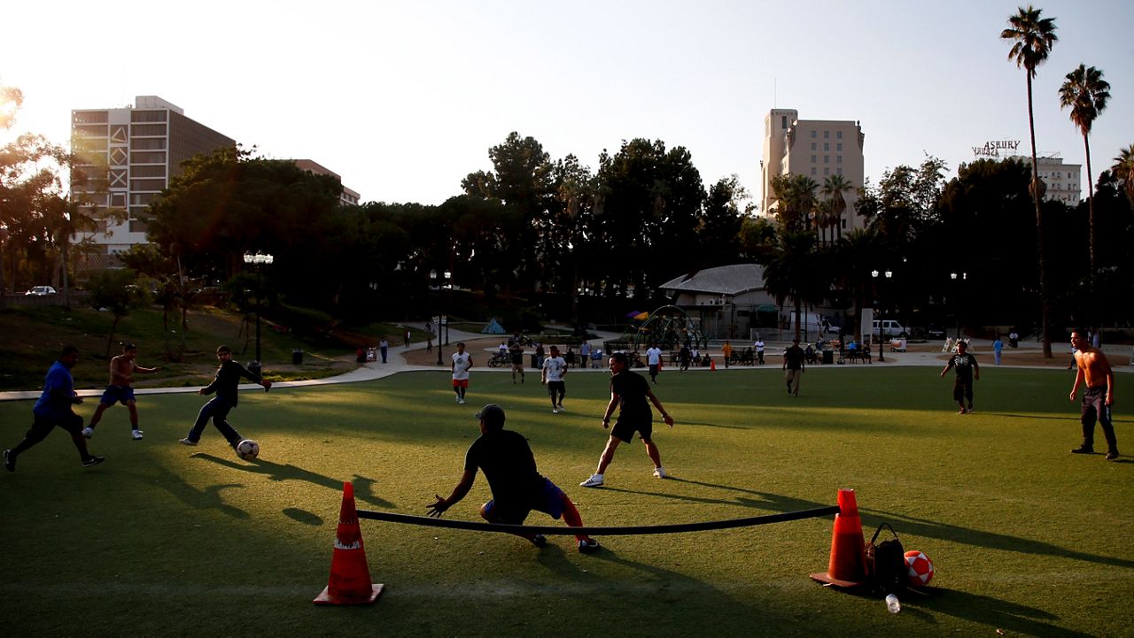 In this Sept. 25, 2012, file photo, people play soccer at MacArthur Park in Los Angeles. (AP Photo/Jae C. Hong)