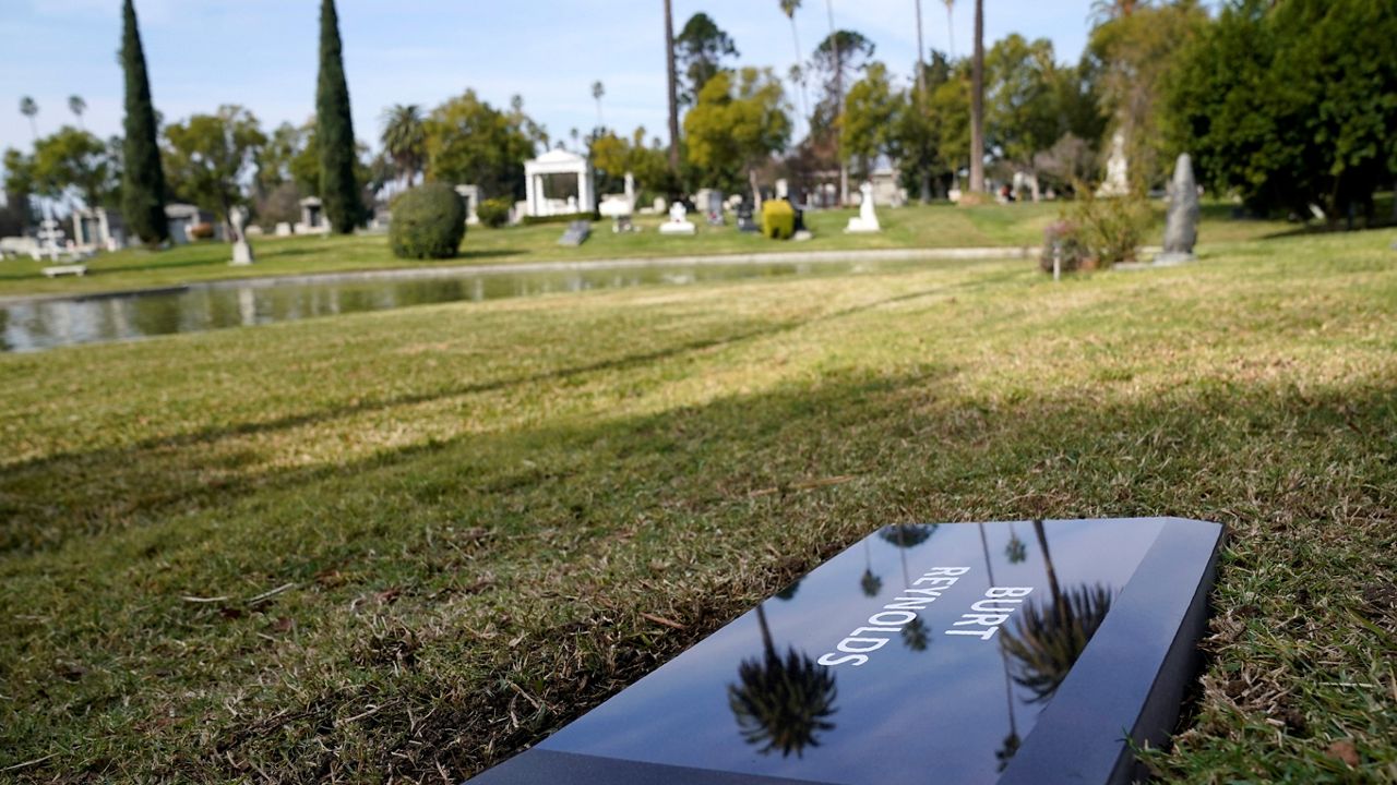 In this Feb. 11, 2021, file photo, a temporary headstone for the late actor Burt Reynold is shown in the Garden of Legends section of Hollywood Forever Cemetery. (AP Photo/Chris Pizzello)
