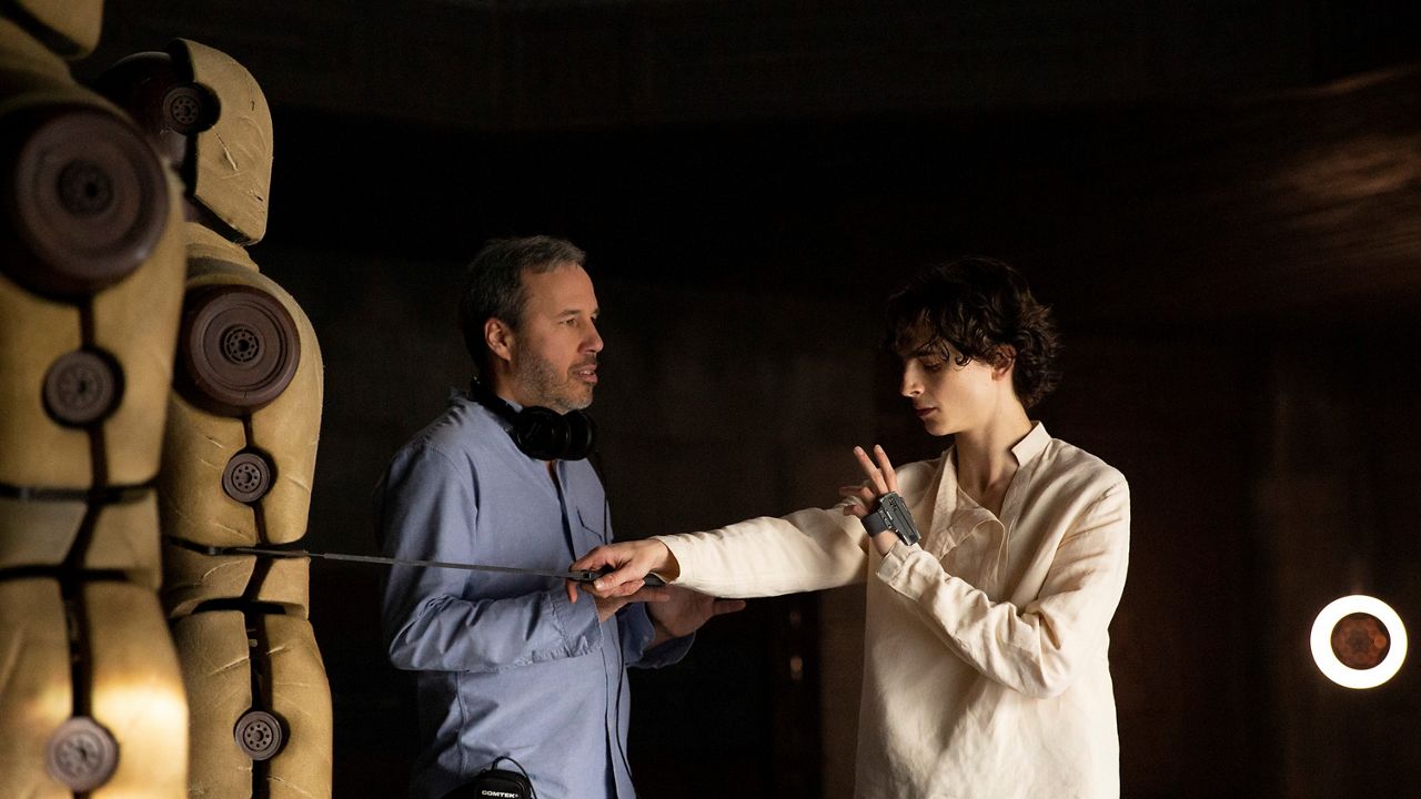 This image released by Warner Bros. Pictures shows director Denis Villeneuve, left, with actor Timothee Chalamet on the set of "Dune." (Chia Bella James/Warner Bros. Pictures via AP)