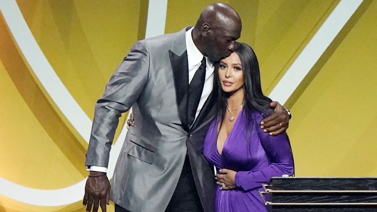 In this May 15, 2021, file photo, presenter Michael Jordan kisses Vanessa Bryant on the head after Bryant spoke on behalf of her late husband, Kobe Bryant, who was enshrined as part of the 2020 Basketball Hall of Fame class in Uncasville, Conn. (AP Photo/Kathy Willens)