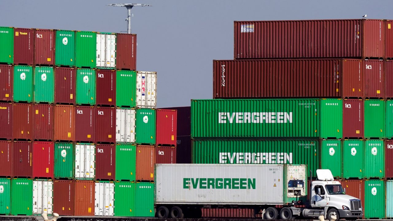 Shipping containers are stacked over a truck Wednesday at the Port of Los Angeles in Los Angeles. (AP Photo/Marcio Jose Sanchez)