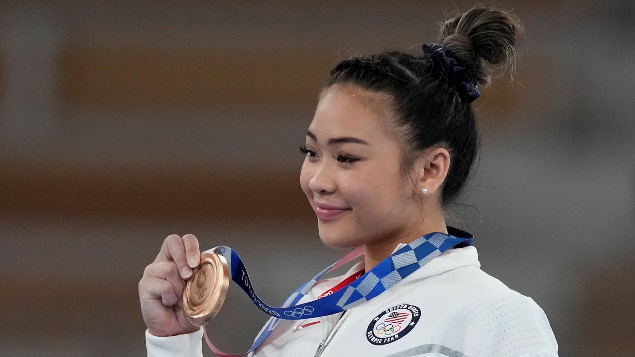 In this Aug. 1, 2021, file photo, Sunisa Lee of the United States poses after winning the bronze medal on the uneven bars during the artistic gymnastics women's apparatus final at the 2020 Summer Olympics in Tokyo, Japan. (AP Photo/Ashley Landis)