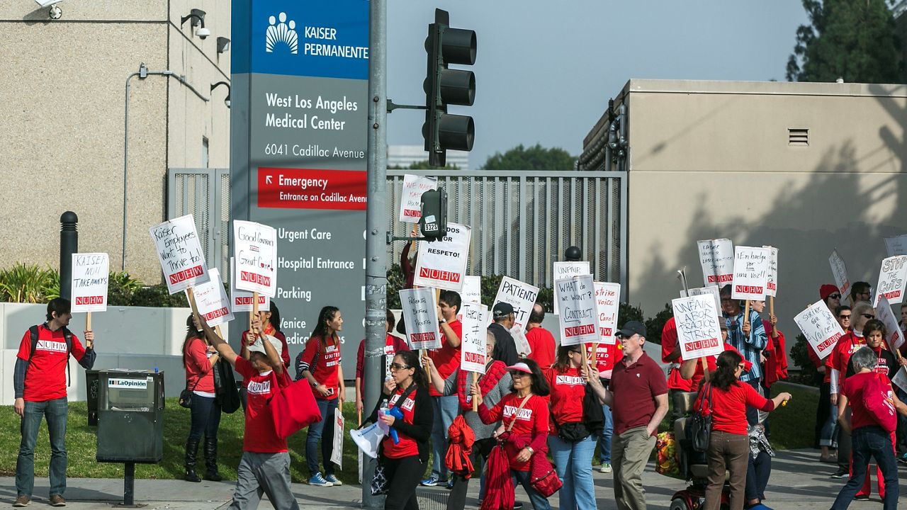 In this Jan. 12, 2015, file photo, Kaiser Permanente mental health professionals rally outside the Kaiser Permanente West Los Angeles Medical Center in Los Angeles. (AP Photo/Damian Dovarganes)