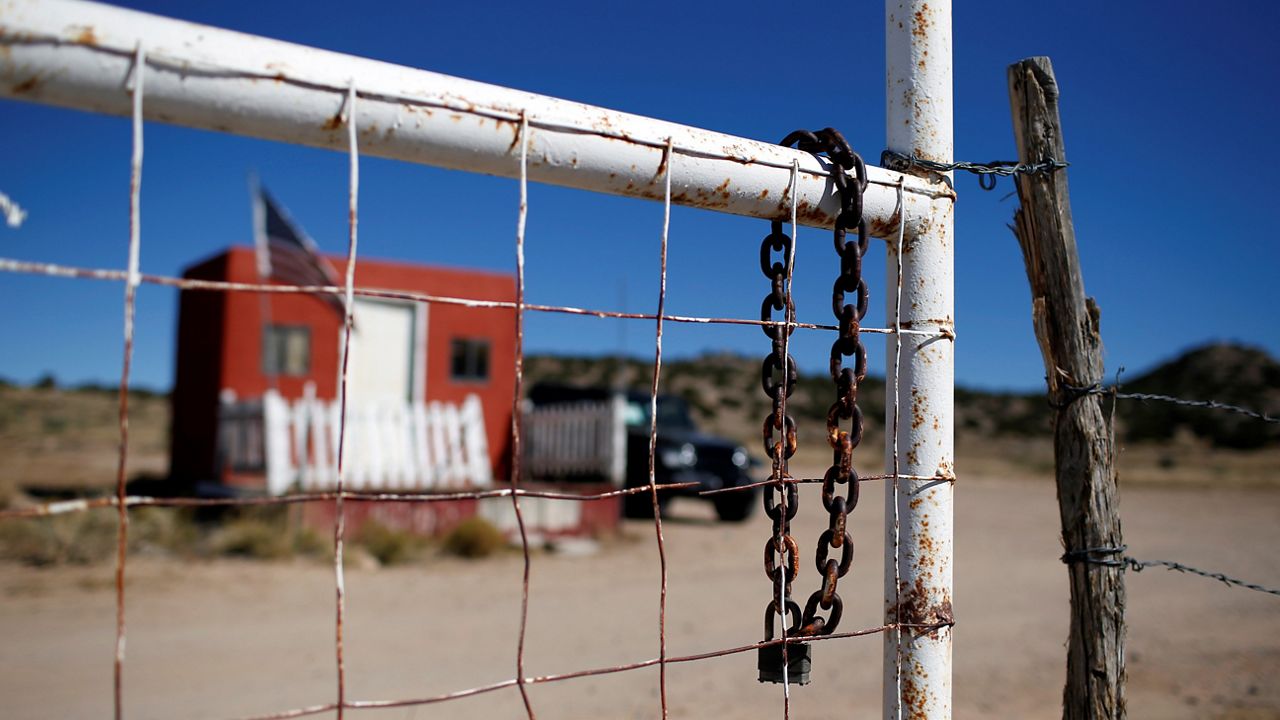 In this Oct. 27, 2021, file photo, a rusted chain hangs on the fence at the entrance to the Bonanza Creek Ranch film set in Santa Fe, N.M. (AP Photo/Andres Leighton)
