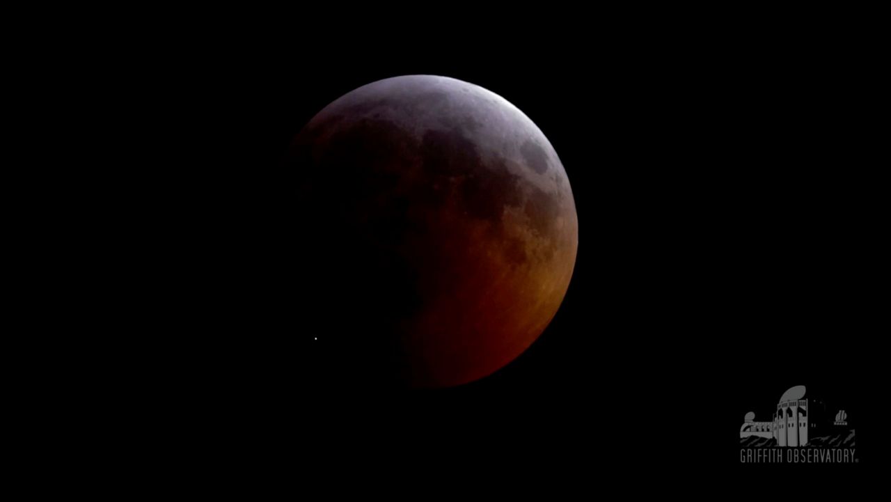 This image from video provided by Griffith Observatory in Los Angeles shows an impact flash on the moon, bottom left, during the lunar eclipse, which happened on Jan. 20, 2019. (Griffith Observatory via AP)