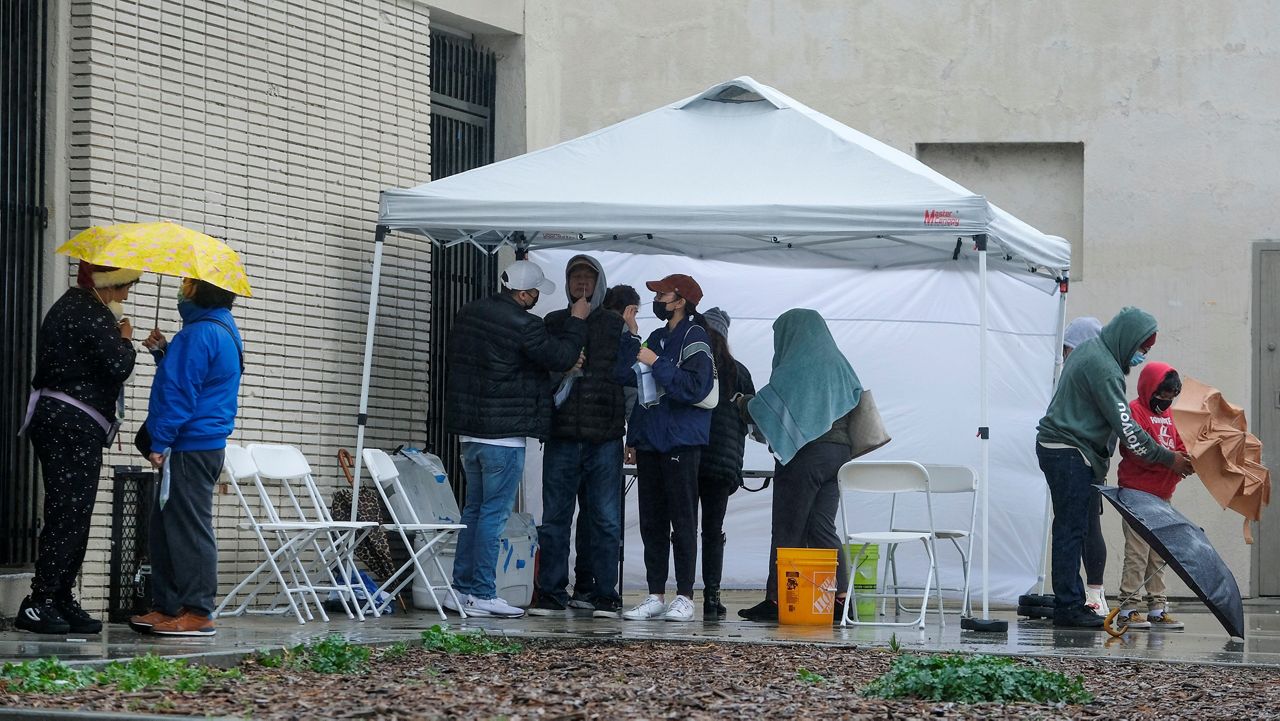 People take their free COVID-19 test Thursday outside Lincoln Park Recreation Center in Los Angeles. (AP Photo/Ringo H.W. Chiu)