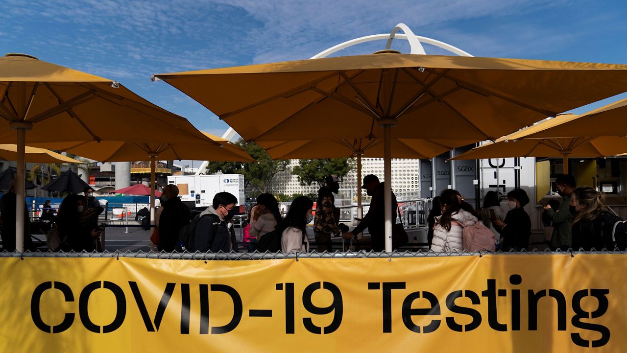 Travelers wait in line to get tested for COVID-19 at Los Angeles International Airport in Los Angeles on Monday. (AP Photo/Jae C. Hong)