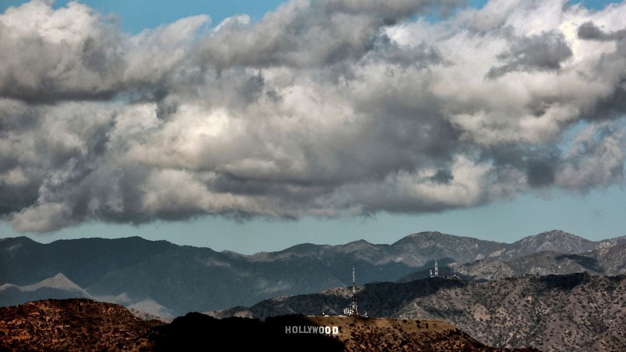 In this Dec. 26, 2021, file photo, heavy storm clouds move in over the hills of the Hollywood sign in Los Angeles. (AP Photo/Richard Vogel)