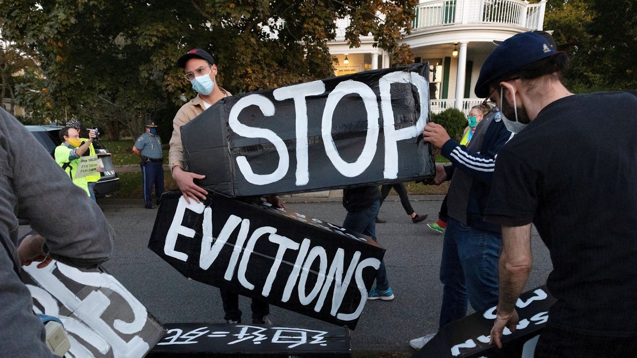 In this Oct. 14, 2020, file photo, housing activists erect a sign in Swampscott, Mass. A federal freeze on most evictions is set to expire soon. The moratorium, put in place by the Centers for Disease Control and Prevention in September, was the only tool keeping millions of tenants in their homes. (AP Photo/Michael Dwyer, File)