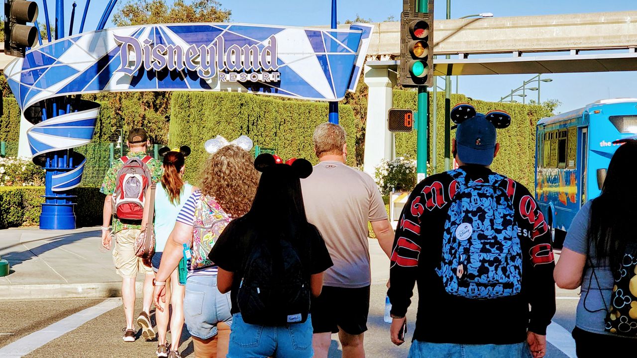 People walk toward one of the entrances of Disneyland Resort. (Spectrum News/Joseph Pimentel)