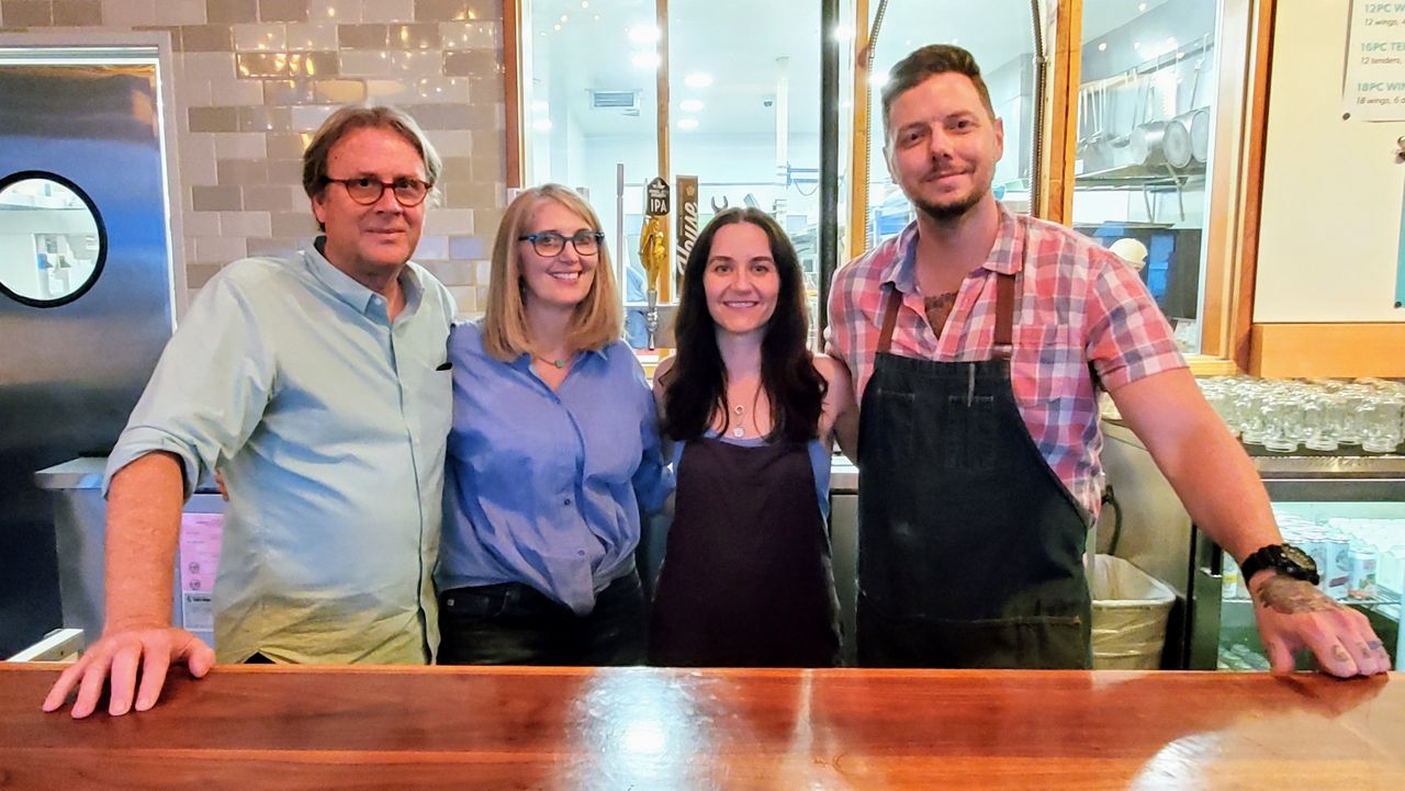 Rick Wetzel, Elise Wetzel, Christine Dane and Chris Dane pose behind the bar at Lucky Bird Fried Chicken in Eagle Rock (Spectrum News/Joseph Pimentel)