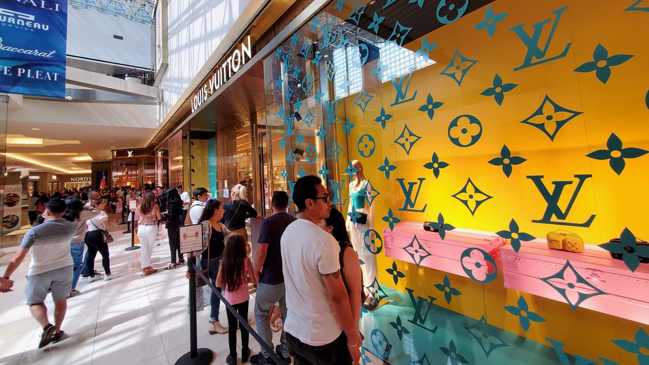 People wait in line to get inside the Louis Vuitton store at the South Coast Plaza (Spectrum News/Joseph Pimentel)