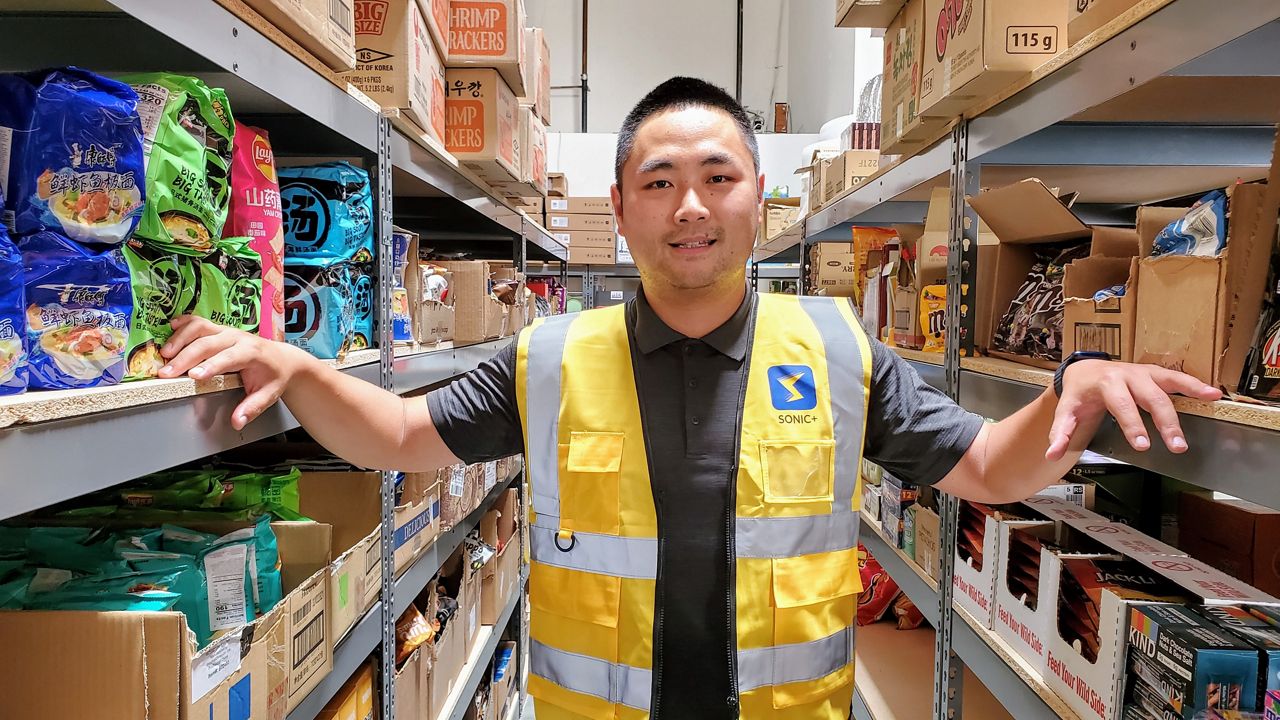 Sonic+ CEO and co-founder Jay Zhao stands in the middle of his micro-fulfillment center in Irvine (Spectrum News/ Joseph Pimentel)