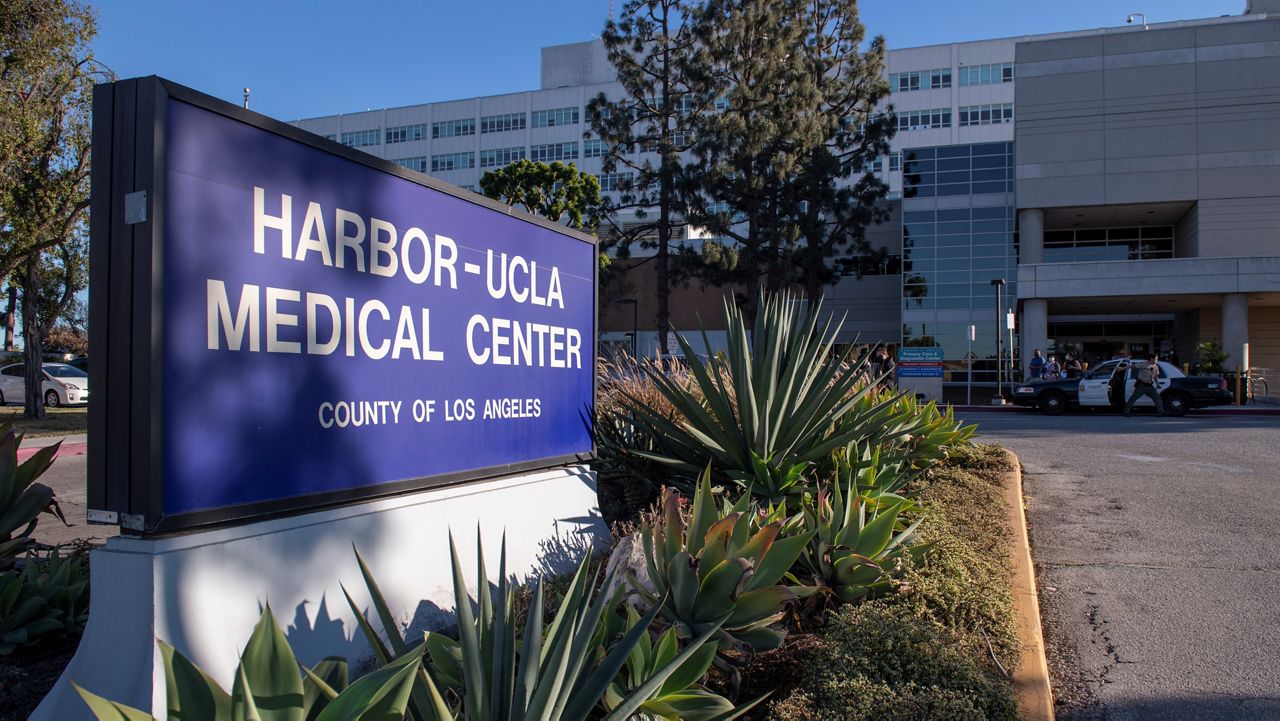 In this Feb. 23, 2021, file photo, a sheriff's car is parked outside of Harbor-UCLA Medical Center in Torrance, Calif. (AP Photo/Kyusung Gong)