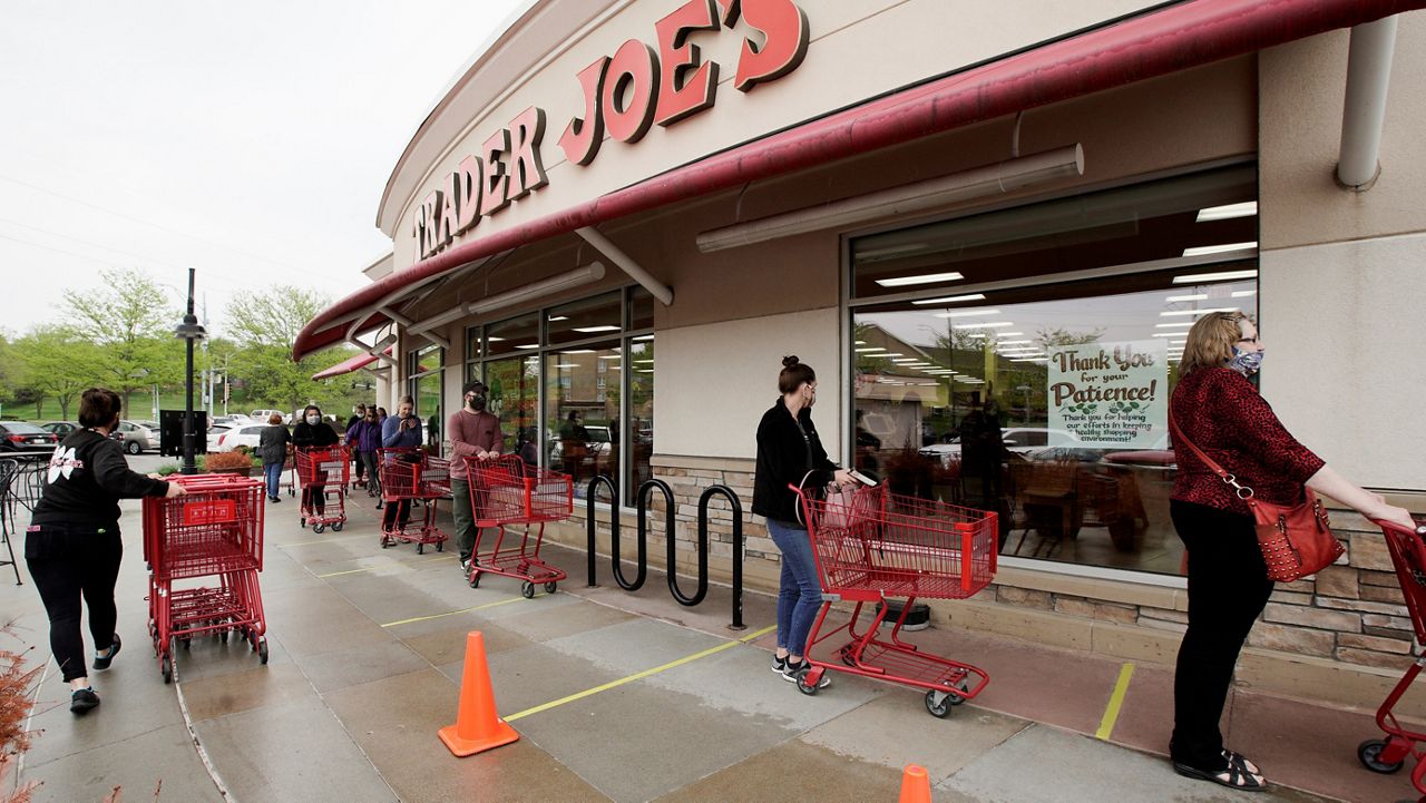 In this May 7, 2020, file photo, customers observe social distancing as they wait to be allowed to shop at a Trader Joe's in Omaha, Nebraska. (AP Photo/Nati Harnik)