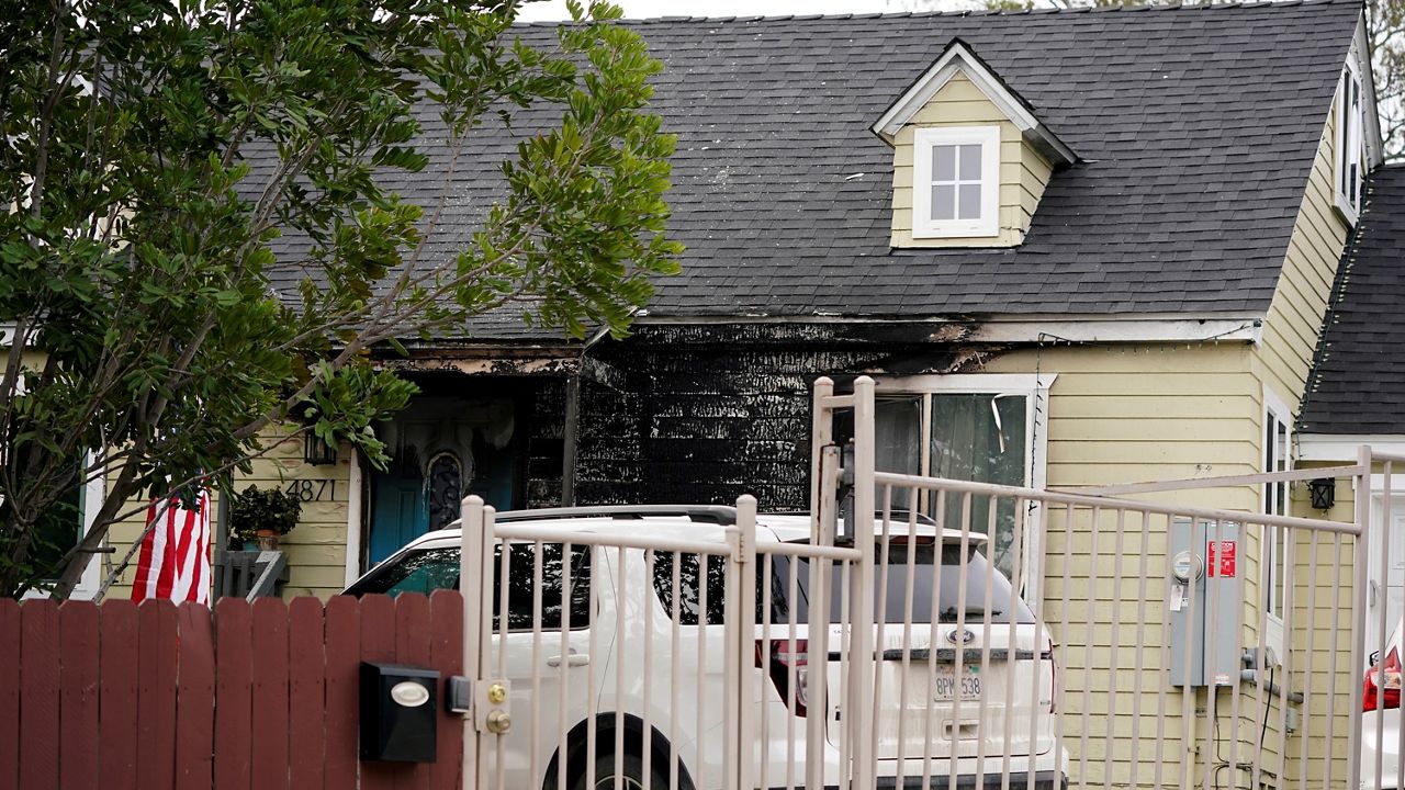 Fire damage covers the front of the house of San Diego County Supervisor Nathan Fletcher Wednesday in San Diego. The chair of the San Diego County Board of Supervisors and his family escaped a fire that damaged the front of their home early Wednesday. (AP Photo/Gregory Bull)