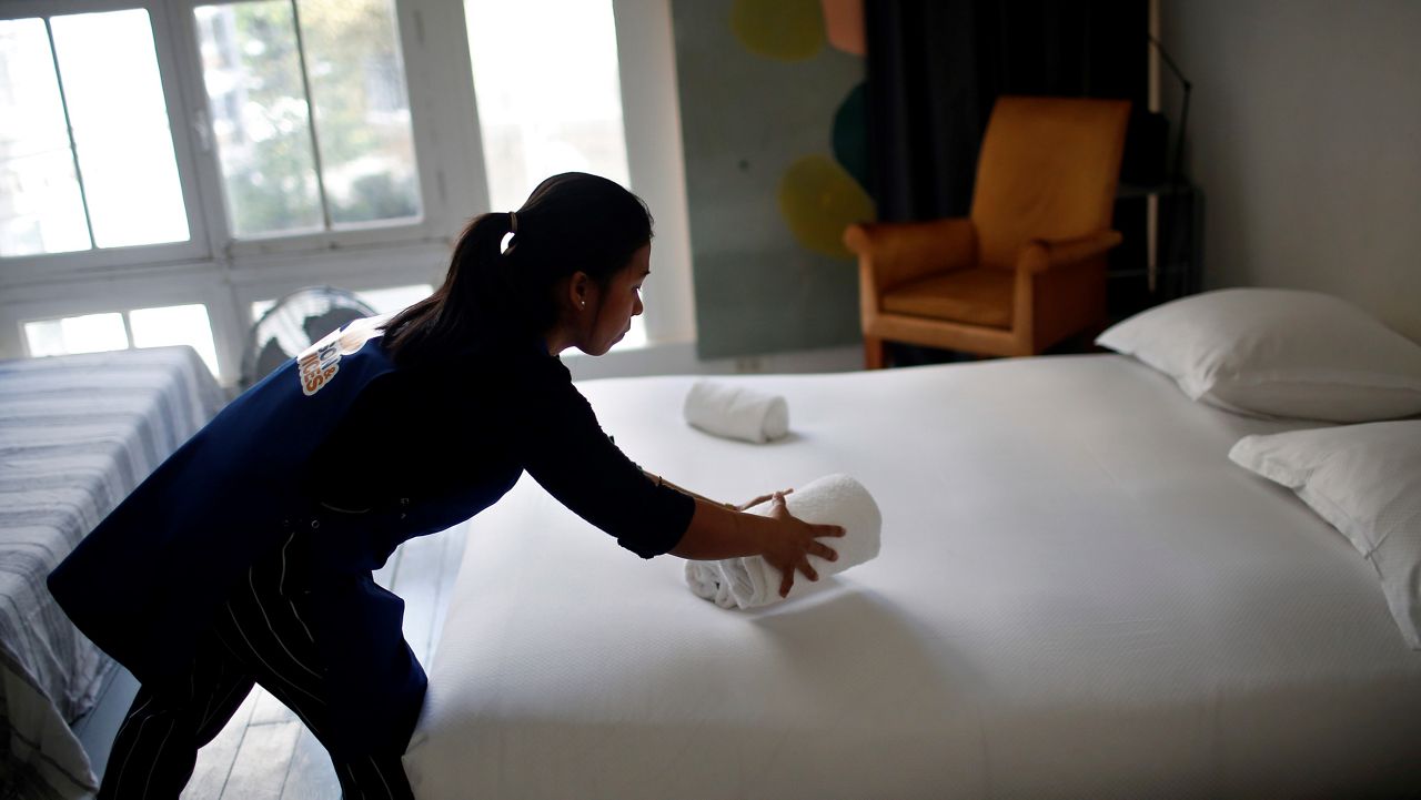 In this Sept. 20, 2018, file photo, a cleaner works in an Airbnb apartment in Paris. (AP Photo/Thibault Camus)