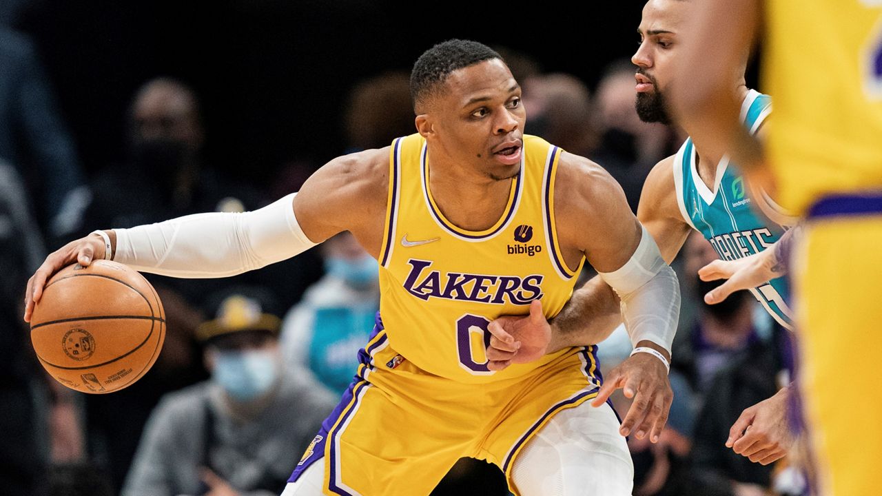 Los Angeles Lakers guard Russell Westbrook (0) is guarded by Charlotte Hornets forward Cody Martin (11) during the first half of an NBA basketball game Friday in Charlotte, N.C. (AP Photo/Jacob Kupferman)