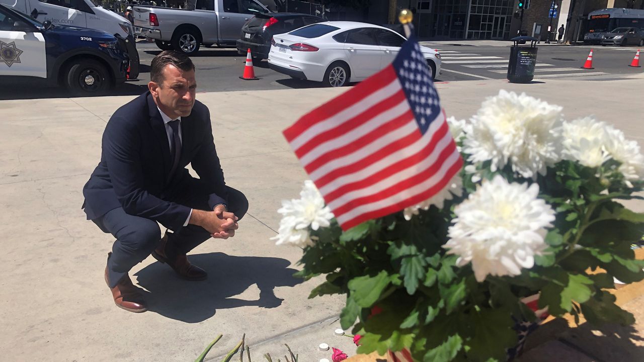 In this May 27, 2021, file photo, San Jose Mayor Sam Liccardo stops to view a makeshift memorial for the rail yard shooting victims in front of City Hall in San Jose, Calif. San Jose officials passed a gun law that requires gun owners to carry liability insurance. (AP Photo/Haven Daley)