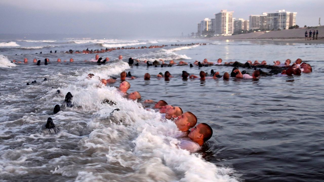 In this May 4, 2020, file photo provided by the U.S. Navy, SEAL candidates take part in “surf immersion” during Basic Underwater Demolition/SEAL (BUD/S) training at the Naval Special Warfare Center in Coronado, Calif. (MC1 Anthony Walker/U.S. Navy via AP)