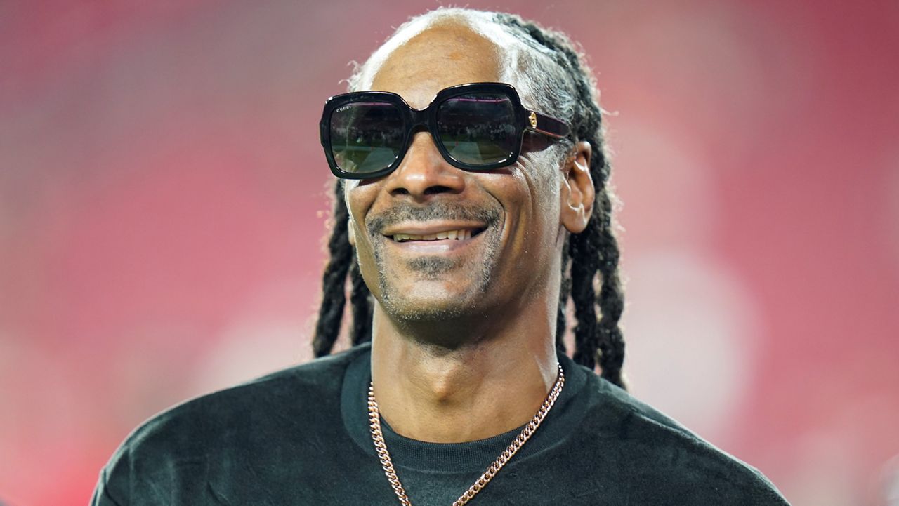 Entertainer Snoop Dogg walks on the field before an NFL football game between the Tampa Bay Buccaneers and the New Orleans Saints Sunday, Dec. 19, 2021, in Tampa, Fla. (AP Photo/Chris O'Meara)