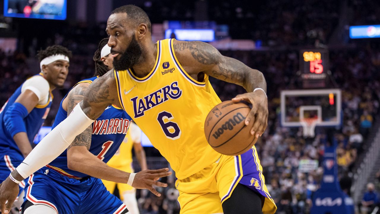 LeBron James makes history as Warriors edge Lakers 117-115